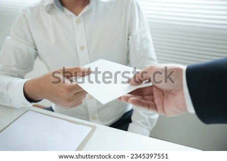 Businessmen receive salary or bonuses from management or Boss. Company give rewards to encourage work. Smiling businessman enjoying a reward at the desk in the office.
