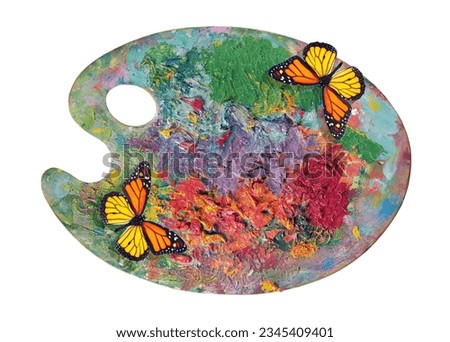 bright monarch butterflies and colorful artist palette isolated on white. palette with paints