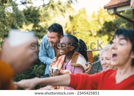Diverse people having fun together in the backyard gathering party