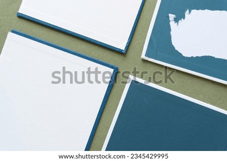 frame composed of discarded hardcovers with torn elements arranged in a cross 