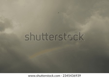 Rainbow in front of dramatic clouds