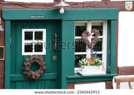 Window and door of a half-timbered house. The old house is a listed building. Royalty-Free Stock Photo #2345442913