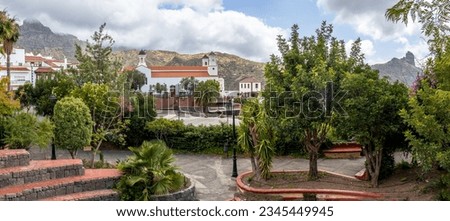 Panoramic photograph from a park in Tejeda, one of the most beautiful towns in Spain. In the center the Church and in the background to the left Roque Bentayga and to the right Roque Nublo. Gran Canar Royalty-Free Stock Photo #2345449945