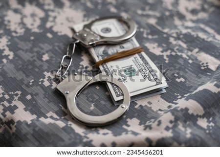 military uniform and handcuffs, money. War criminal, criminal liability of military personnel, bribe taker