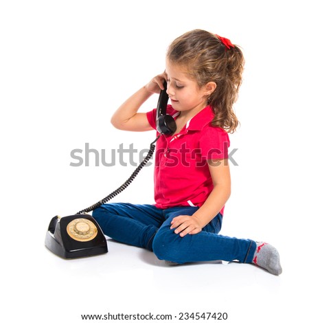 Blonde little girl with vintage phone