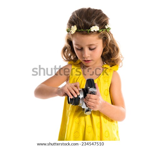 Blonde little girl holding a camera
