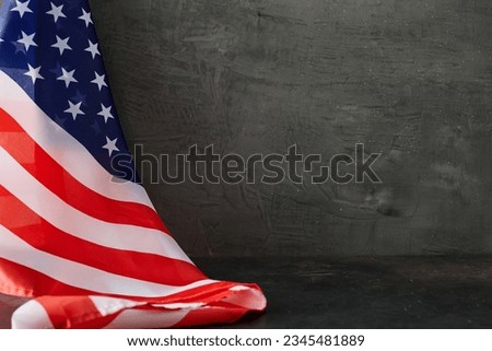 Immersing in the essence of American Labor Day. Side view of american national flag on grey concrete background with empty space for advert or text
