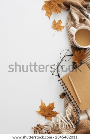 Enchanting fall aesthetic concept. Top view vertical photo of fragrant coffee, comfortable blanket, eyewear, pen, notepad, acorns, autumn leaves on white background with empty space for advert or text