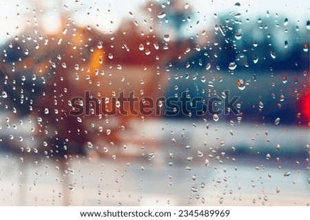 picture of a mirror having water droplets on it after raining