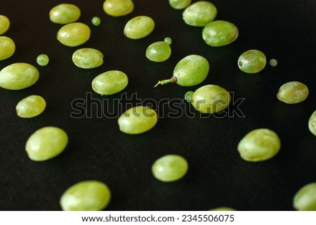 Abstract lying grapes on a black background