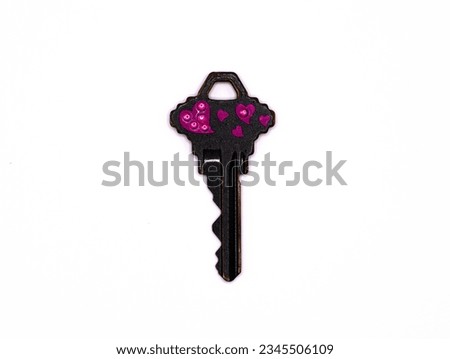 Black Key with pink hearts on a white background