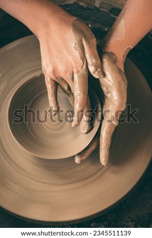 Throwing pottery on the wheel Royalty-Free Stock Photo #2345511139