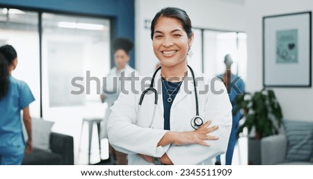 Face, doctor and arms crossed in busy hospital for about us, medical life insurance or wellness support. Smile, happy and healthcare woman in portrait, confidence trust or clinic medicine leadership Royalty-Free Stock Photo #2345511909