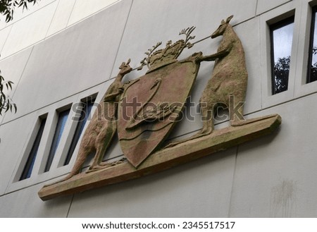 West Australian coat of arms outside the Central Law Courts in Perth has two kangaroos and the state symmbol a black swan