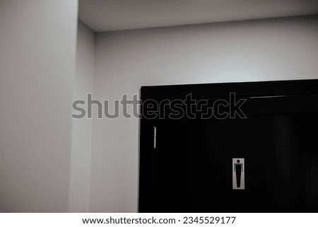 A closeup shot of a sign of men's restroom on a door