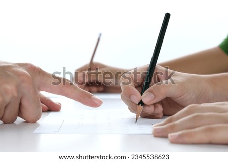 Children's hands studying in classroom with teacher Royalty-Free Stock Photo #2345538623