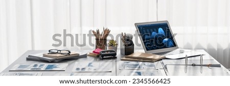 Business intelligence and data analysis workspace. Data analysis dashboard on laptop screen and business financial document on office table as marketing indication for strategic planning. Insight Royalty-Free Stock Photo #2345566425