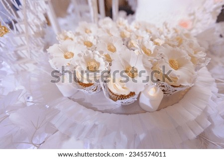 festive set of cupcakes decorated with marzipan flowers, candy bar