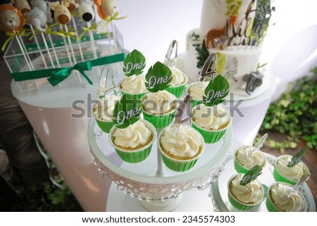 festive set of cupcakes decorated with marzipan flowers, candy bar