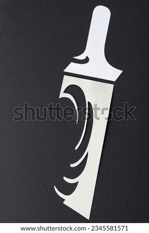abstract or stylized paint brush (or unique shape) machine-cut from white paper on black