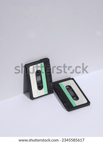 Retro 80s audio cassettes on white background with shadow. Creative layout, minimalism, music lover