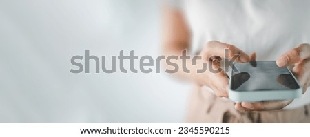 Close up of woman using smartphone over white background with copyspace for put text,icon,logo concept for banner,wallpaper,background idea. Royalty-Free Stock Photo #2345590215