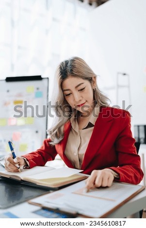 Consultant, advisor, Asian business woman working on the tablet computer work financial and marketing business plan to increase company profits, ready to use computer and marketing planning documents.