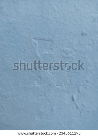 Uneven surface bright blue wall