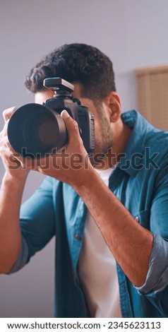 Professional male photographer working in studio.