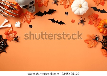 Happy Halloween holiday concept. Halloween decorations, spiders, pumpkins, bats, ghosts, maple leaves on orange background.  Flat lay, top view, copy space.