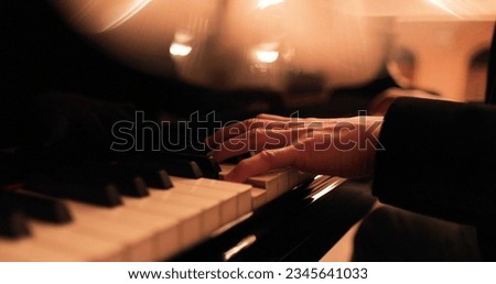 Male hands playing the piano. Professional piano playing close-up. Royalty-Free Stock Photo #2345641033