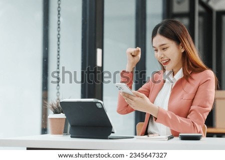 Excited Female secretary business woman in South Korean workplaces, feeling euphoric celebration online win success achievement result rejoicing over good news, raise up hands, good email news
