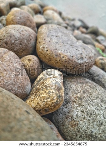 Close up of maroon river rocks.