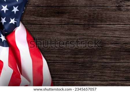 Stars and stripes American flag on rustic wooden background, copy space. The pride of the American people. Symbol of independence, freedom and patriotism in the USA.