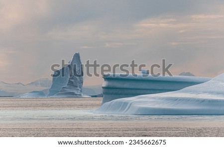 Multi-faceted ice grotto; Nice light on a sculpted iceberg; Panorama, icebergs, cloud mountains; Pastel light, on sculpted icebergs; Scoresby Sund, Greenland
