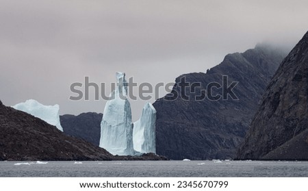 Sun behind iceberg; Scoresby Sund, Greenland; Sun hiding behind iceberg; Scoresby Sund, Greenland