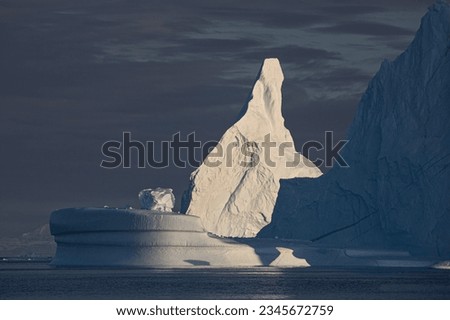 Rotunda with ice boulder; Scoresby Sund, Greenland; Rotunda berg shooting, into the light; Scoresby Sund, Greenland; Rotunda iceberg, catching evening light; Scoresby Sund, Greenland