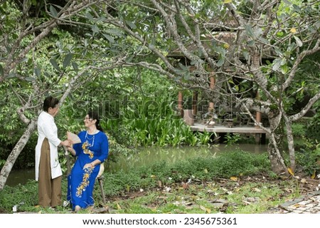 Portrait of Asian and Caucasian woman in Ao Dai Dress in the garden 