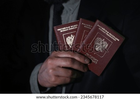 Traveling businessman handing passport black background