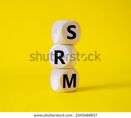 SRM - Sustainability Risk Management symbol. Wooden cubes with word SRM. Beautiful yellow background. Business and Finace and SRM concept. Copy space.