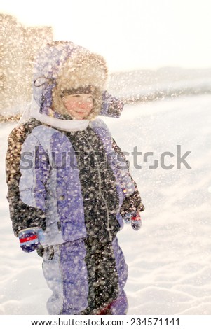 Little boy have fun in snow outdoors winter