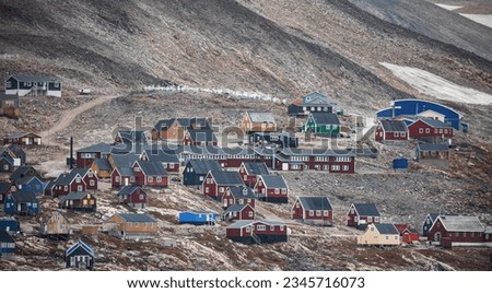 Graveyard Colorful houses; Graveyard; Green house by the shore; Scoresby Sund, Houses below snow covered mountains; Ittoqqortoormiit, Greenland
