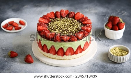 A classic Fraisier cake, elegantly layered with pistachio Crème Diplomat and fresh strawberries, showcasing the art of French patisserie Royalty-Free Stock Photo #2345718439