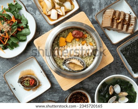 Korean traditional food, various side dishes and abalone pot rice Royalty-Free Stock Photo #2345720165