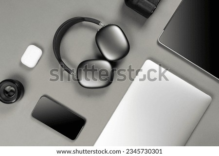 Set of modern gadgets on a beautiful dark or gray background with headphones, laptop, phone, joystick and camera
 Royalty-Free Stock Photo #2345730301