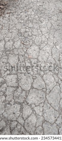 photo of cracked and unsturdy concrete road surface.
