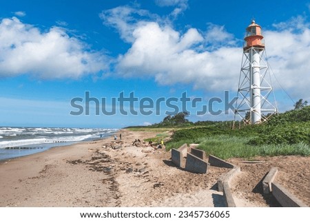 Pape Lighthouse, located on the Latvian coast of the Baltic Sea, built in 1910 Royalty-Free Stock Photo #2345736065