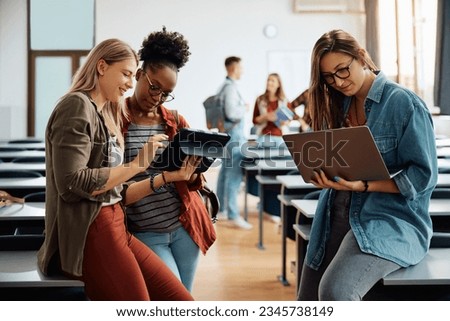 University students using wireless technology while studying in the classroom. Royalty-Free Stock Photo #2345738149