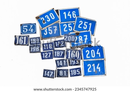 metal plates representing numbers to hang in front of houses on a white background