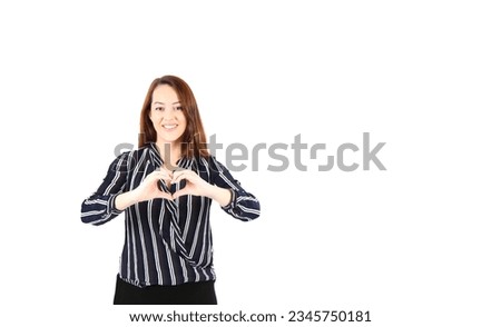 Confident young brunette business woman doing a heart gesture with both hands against a white background